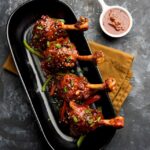 [freepicdownloader.com]-szechuan-chicken-which-is-popular-indo-chinese-non-vegetarian-recipe-served-plate-with-chilli-sauce-selective-focus-large